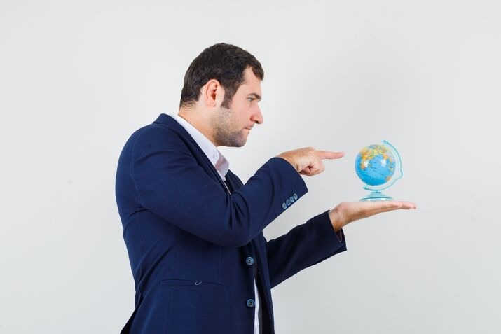 Business professional planning international trademark registration with a globe