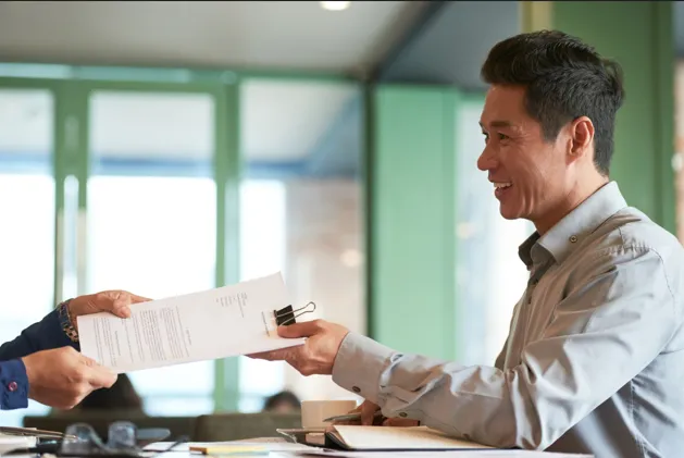 Business professional submitting application documents