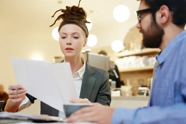 Business professionals reviewing application documents